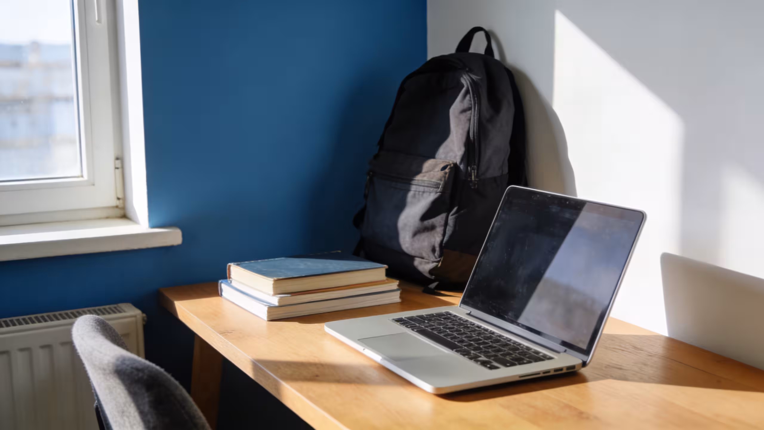 A college student reviewing renters insurance options on a laptop in a bright campus apartment, showcasing affordable coverage for students.