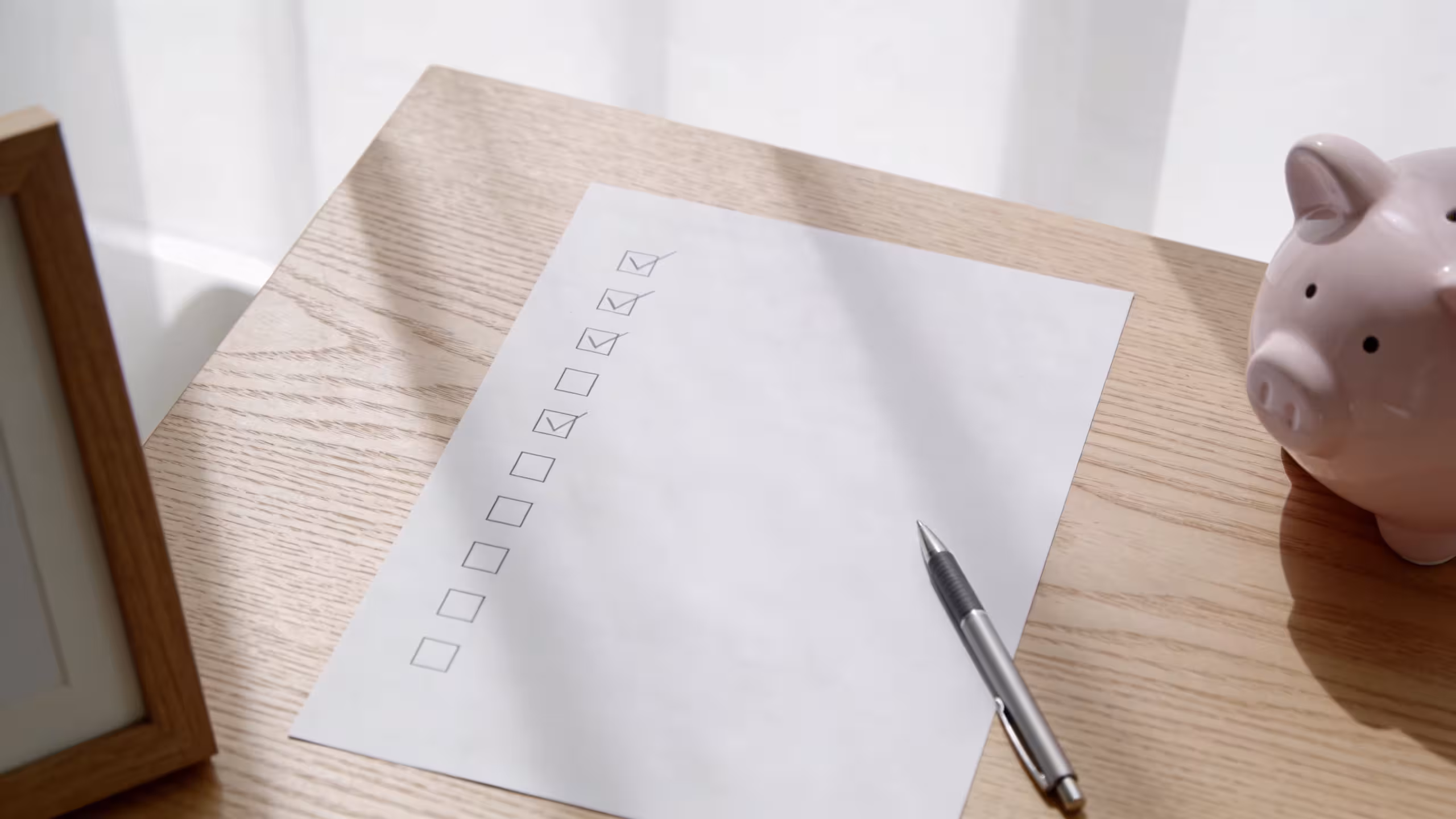 A wooden desk with a notebook, calculator, and financial documents representing how to borrow money without a payday loan
